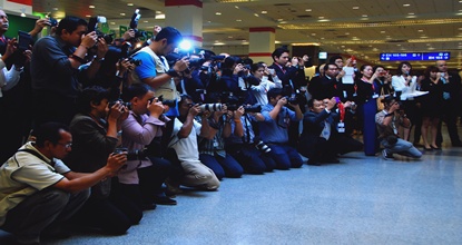 Photographers line up to get the best shot creating a wall of cameras.