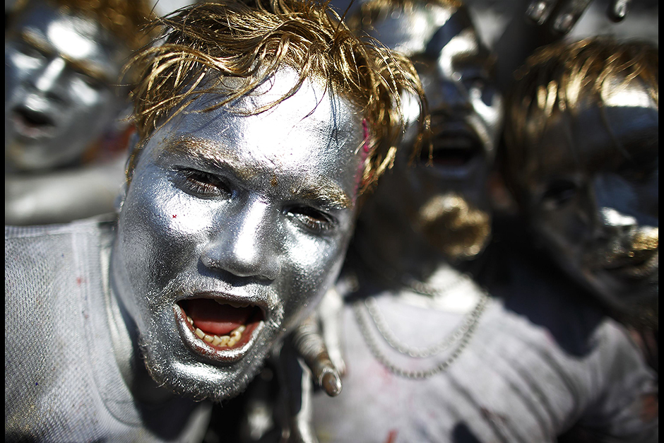 People sing and dance while celebrating Holi, the Festival of Colours, in Kathmandu. Holi heralds the beginning of spring and is celebrated all over Nepal. — Reuters