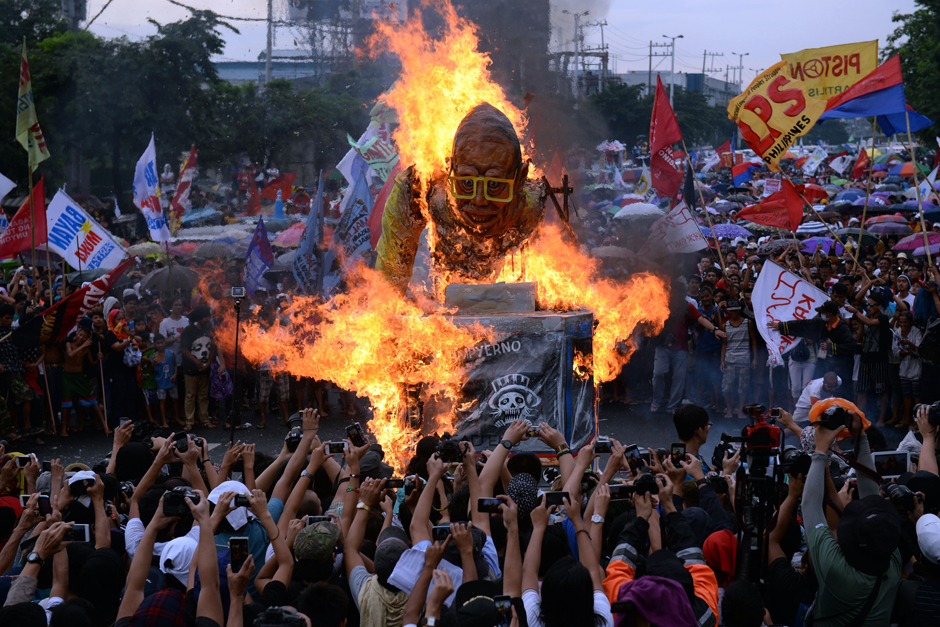 Protesters burn an effigy of Philippine President Benigno Aquino during a rally to coincide with the last State of the Nation Address (SONA) of the president before members of parliament in Manila. Aquino addresses parliament for the last time, racing to secure fragile legacies of peace in the war-torn south and a stronger economy and his political clout fading and struggling to choose a successor for next year's elections that would continue with his agendas, analysts said. - AFP
