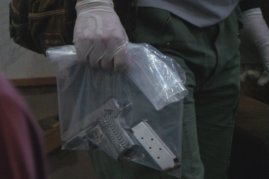Police find a pistol inside a house in Nan province, where a policeman, his nurse wife and their twin sons were found dead, each with a bullet wound to the head. Investigators believed the man killed his wife and their sons on Friday morning and then took his own life. - Rarinthorn Petcharoen