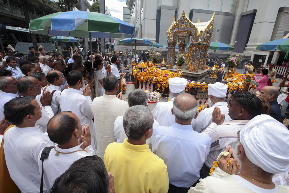 Members of the Indian Association of Thailand pray at the Erawan Shrine in Bangkok's Ratchaprasong district. On Aug 17, an improvised bomb left under a bench at the Hindu shrine went off, killing 20 people, including 14 foreigners, and injuring more than 120 others. The bombing suspect remains at large. - Patipat Janthong