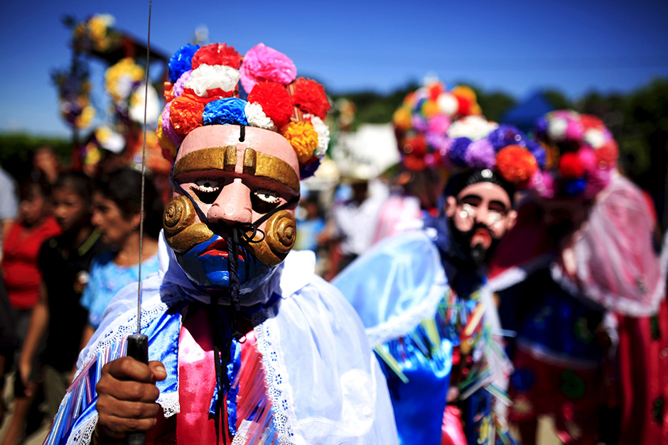 Members of the traditional Los Historiantes dance group perform during a welcoming ceremony for Catholic devotees known as