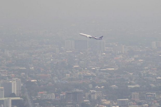 Haze hangs over Chiang Mai as a plane heads out for clearer skies. (EPA photo)