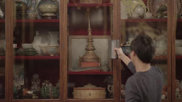 An artist working with the replica of the royal crown at Chateau de Fontainebleau.