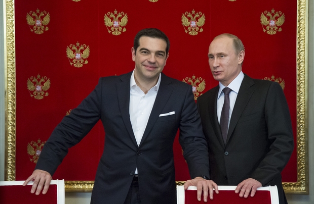 Russian President Vladimir Putin and Greek PM Alexis Tsipras chat during the latter's visit to Moscow earlier this month. Greece didn't explicitly ask the Kremlin for money but might be getting some anyway in the form of an advance payment to operate a pipeline through the country. (EPA Photo)