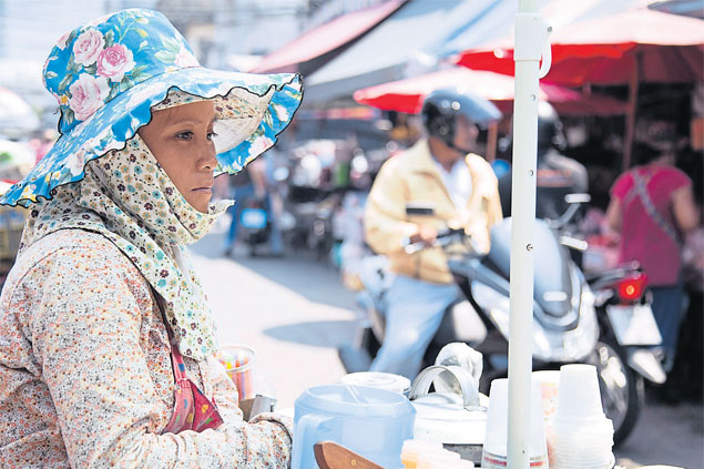 A vendor waits for customers at Klong Toey market. Household debt in Thailand soared to 85% of GDP last year and is likely to hit a record high of 90% this year. NARUPON HINSHIRANAN