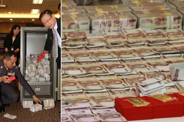 Assistant police chief Suwira Songmeta (left) and Amlo secretary-general Seehanart Prayoonrat oversaw the opening of a safe packed with cash, seized from ponzi scheme suspect Rattawit Titiarunwat. (Photo by Somchai Poomlard)