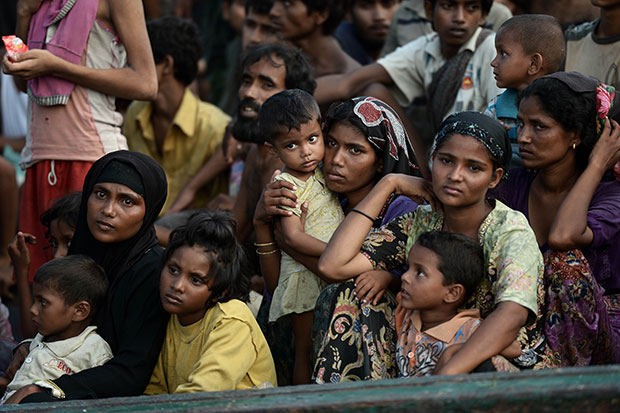 Rohingya migrants sit on a boat drifting in Thai waters off the southern island of Koh Lipe in the Andaman sea on May 14. Human trafficking, not political persecution, is the root cause of the migrant crisis, Myanmar’s president’s office said Friday. (AFP photo)