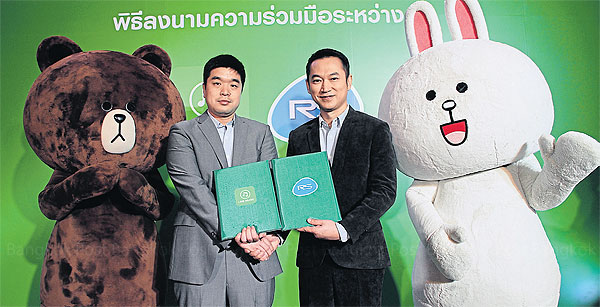 Lim Suk-jun (left), head of Line Music Global, and Soopachai Nillawan, senior executive vice-president of music for RS, pose with popular characters from the Line messaging app.