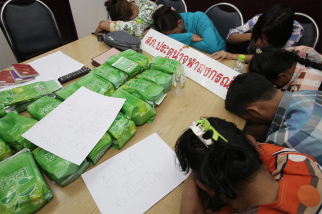 Five female Myanmar nationals and one male hide their faces as they are presented to the media yesterday after being arrested with 14 kilogrammes of crystal methamphetamine in Pathum Thani’s Thanyaburi district. Apichit Jinakul