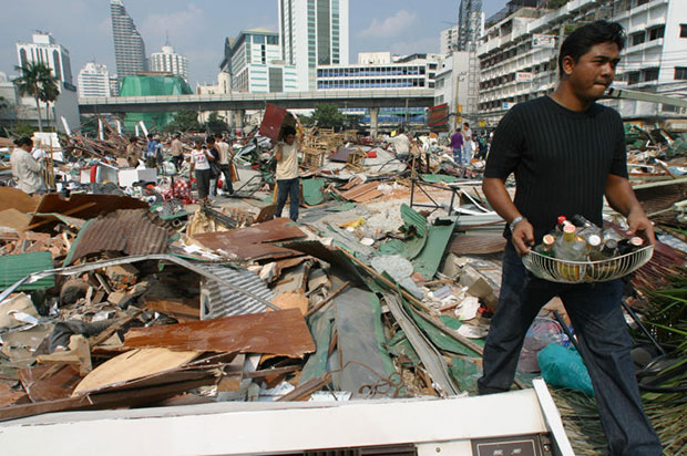 In this photo taken on Jan 27, 2003, traders whose businesses at Sukhumvit Plaza were destroyed in the gangland-style rampage scour through the wreckage hoping to salvage some of their property (Bangkok Post file photo)