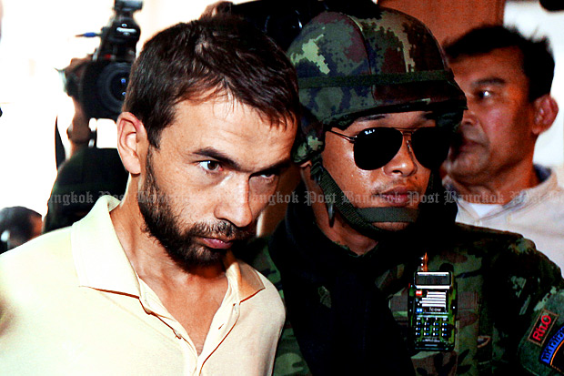 The military hands over bombing suspect Adem Karadag to the Metropolitan Police Bureau on Friday after holding him for seven days. (Photo by Thiti Wannamontha)