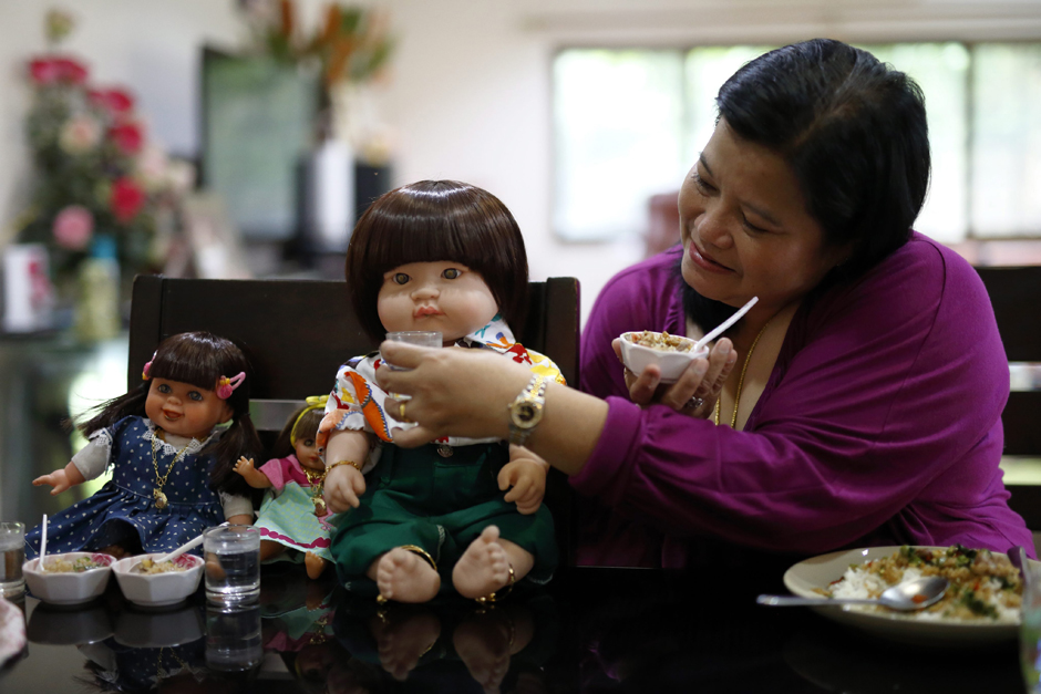 Child Angel dolls are being offered food and drinks by their owner.