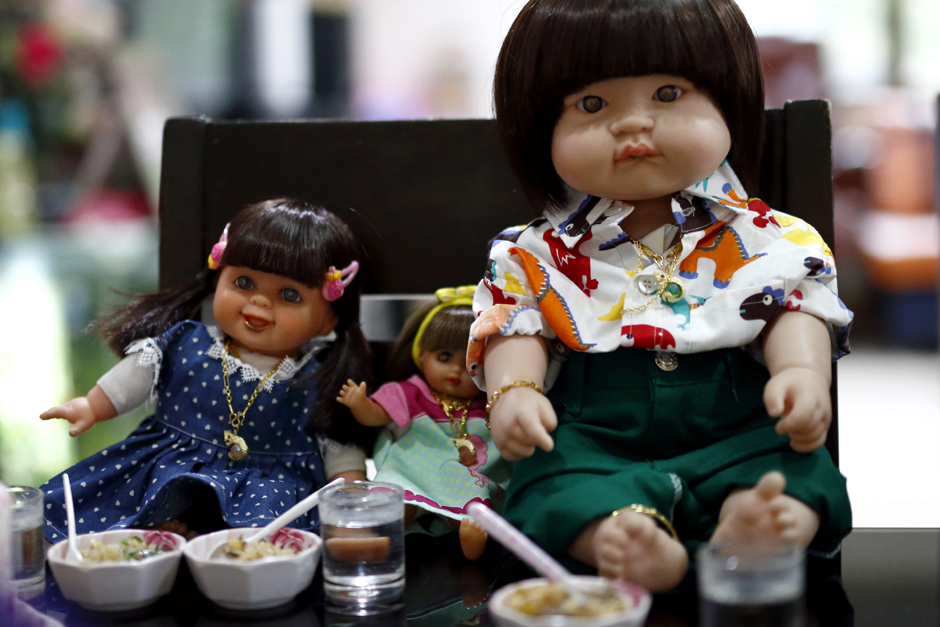 Child Angel dolls are being offered food and drinks by their owner.