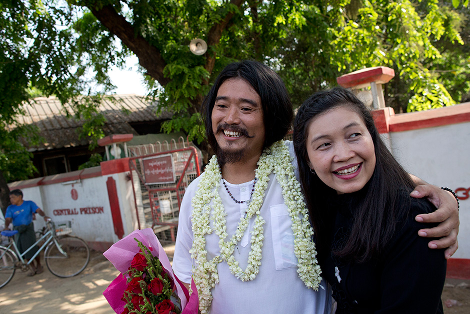 Ethnic Kachin activist Patrick Kum Ja Lee (left) smiles after posing for a picture with his wife and prominent human rights activist May Sabe Phyu outside Insein prison in Yangon. The man, accused of sharing a post poking fun at Myanmar's army chief on Facebook, was released after spending six months in jail. — AP