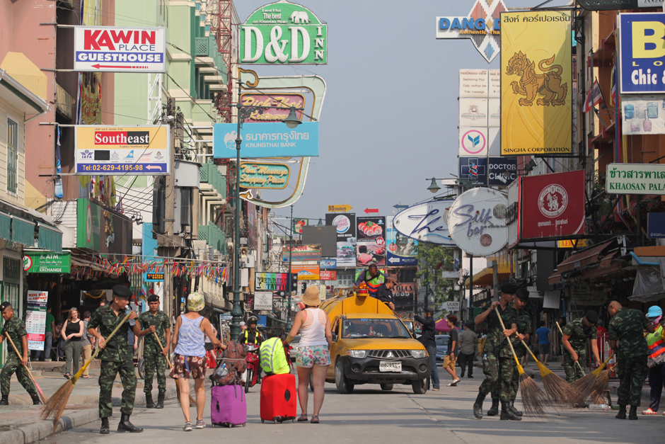 Soldiers and municipal workers clean up the litter left behind by Songkran revellers on Khao San Road, a popular destination in Bangkok. - Wichan Charoenkiatpakul