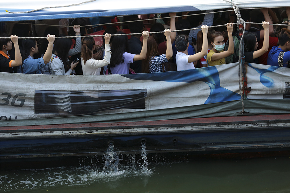 People travel by a commuter boat on Saen Saeb canal, Bangkok, on May 7. The government has plans to clean up the heavily polluted waterway within two years. - Patipat Janthong