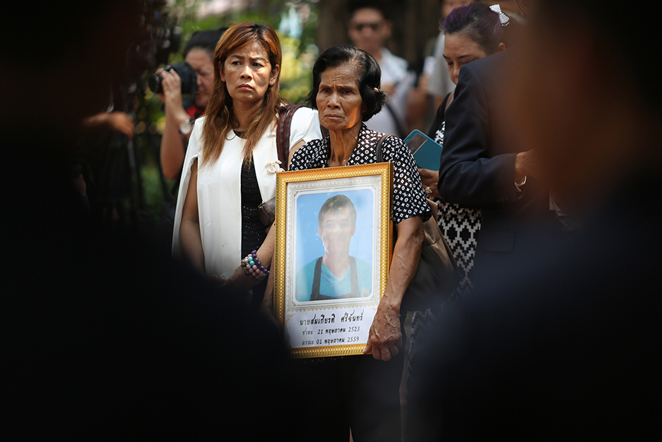 Thongkham Sichan on May 16 holds a portrait of her son Somkiat Sichan, a disabled bread deliveryman stabbed to death by a group of youths, some sons of local police officers, egged on by a teen girl. - Pattanapong Hirunard