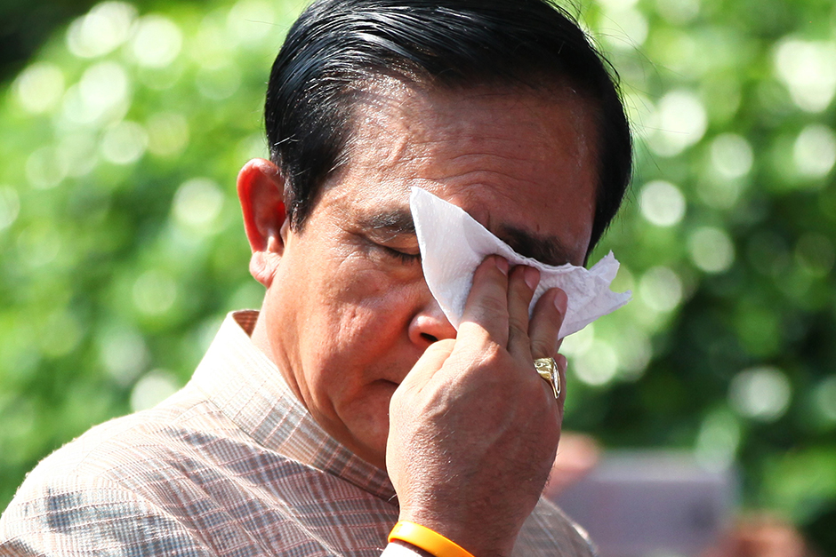 Prime Minister Prayut Chan-o-cha wipes sweat off his brow before attending a weekly cabinet meeting at Government House on May 4. Temperatures in Bangkok soared to 40 degrees Celsius during the month. - Seksan Rojjanametakun