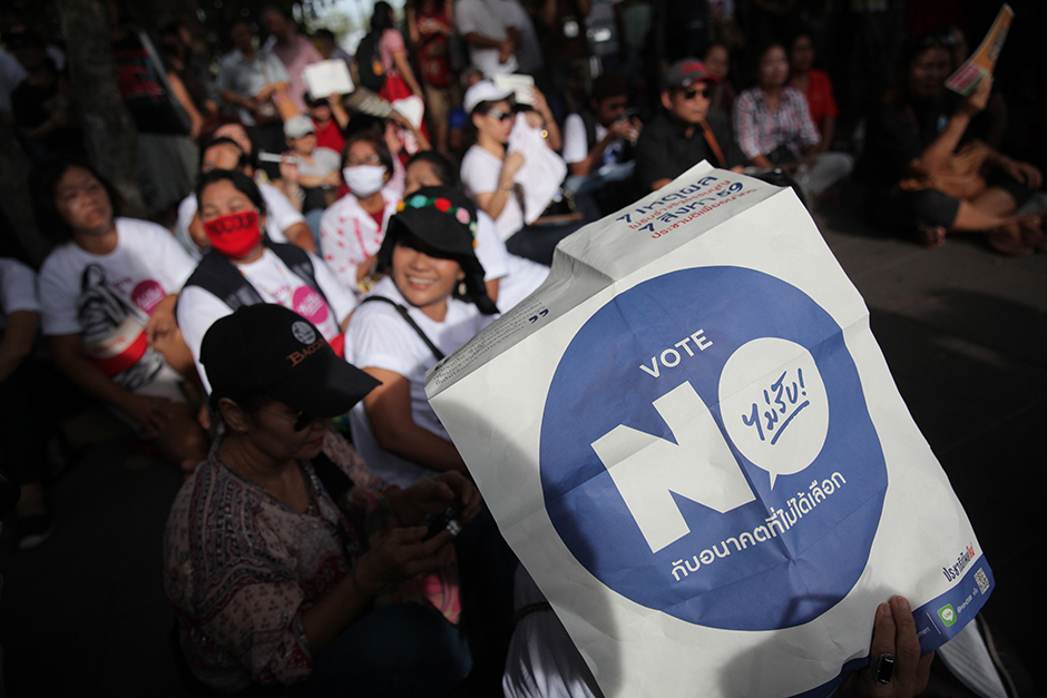 Anti-coup activists rally on the second anniversary of the May 22, 2014 coup at the Democracy Monument. The group had a brief confrontation with opponents before police stepped in. - Wichan Charoenkiatpakul