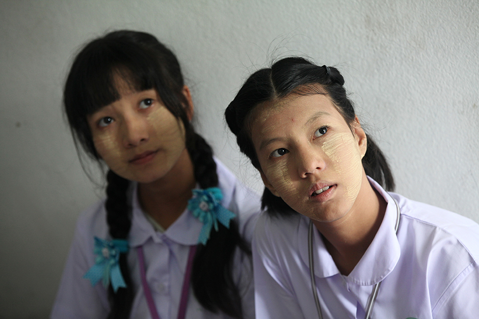Children of Myanmar workers in Thailand get dressed up and wear makeup to greet Suu Kyi. - Seksan Rojjanametakun