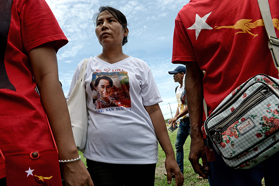 Myanmar migrants wear T-shirts carrying a picture of Suu Kyi, as supporters gather ahead of her visit to the fish market in Samut Sakhon. - AFP