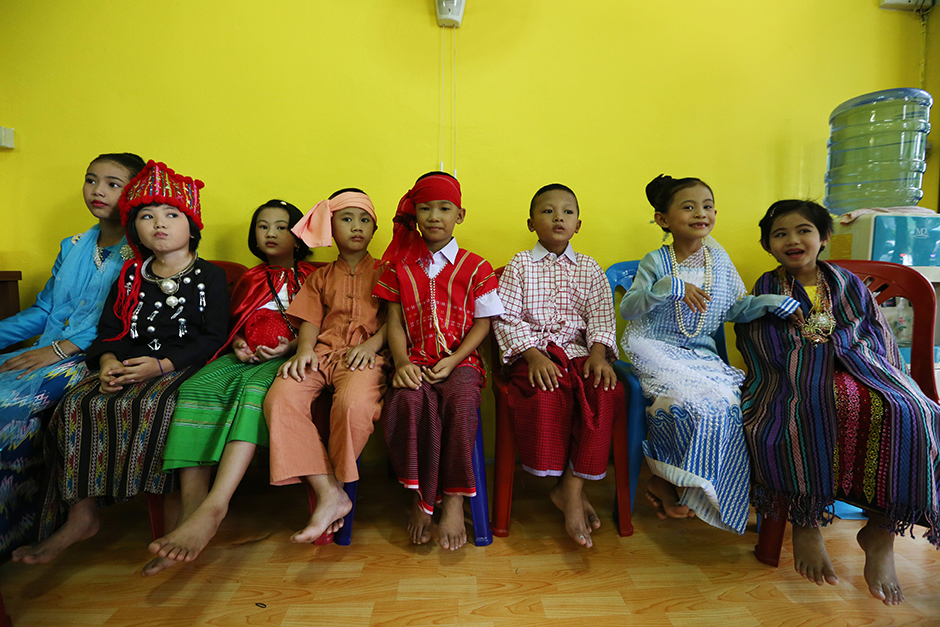 Children of Myanmar workers in Thailand get dressed up and wear makeup to greet Suu Kyi. - Seksan Rojjanametakun