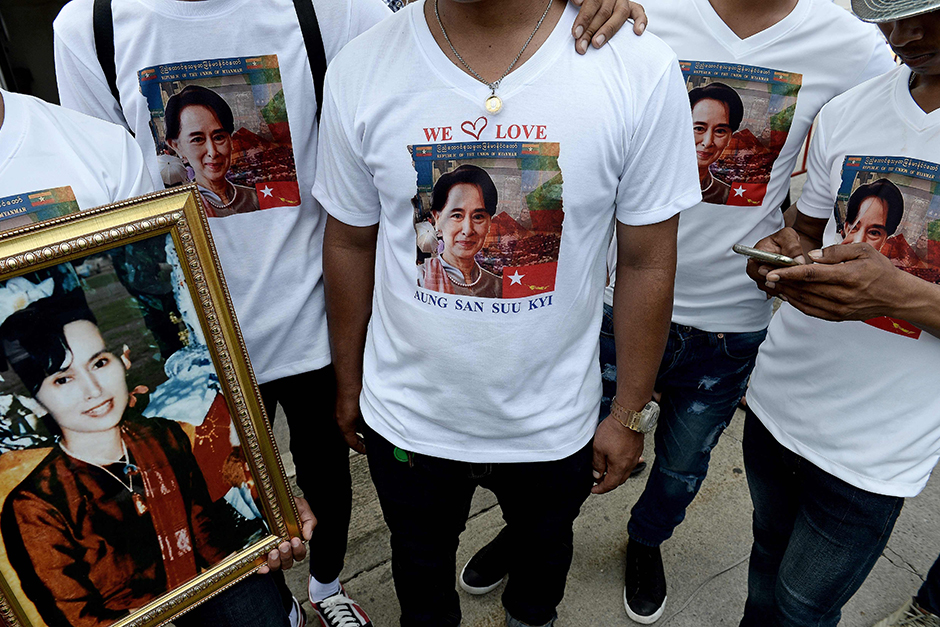 Myanmar migrants wear T-shirts carrying a picture of Suu Kyi, as supporters gather ahead of her visit to the fish market in Samut Sakhon. - AFP