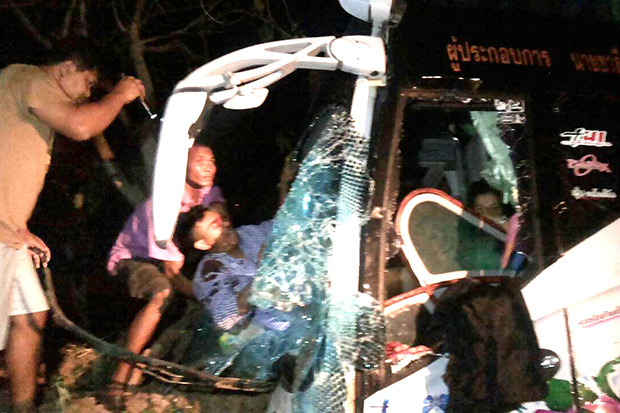 Injured students are pulled from the wreckage of a bus struck by a pickup truck in Kalasin early Wednesday. (Photo by Yongyut Phupuangphet)