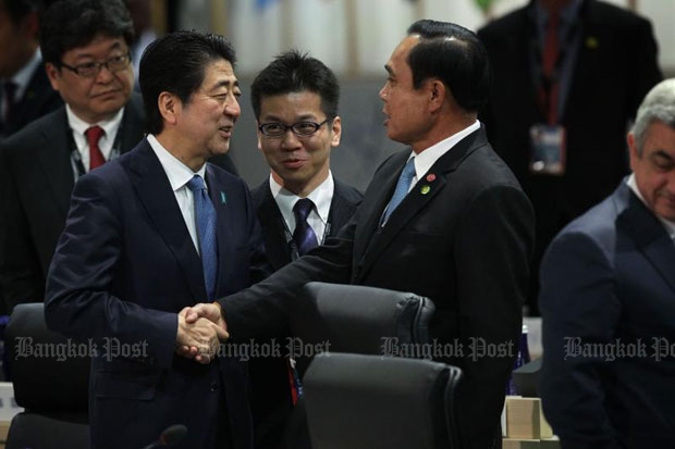 Japanese Prime Minister Shinzo Abe greets Prime Minister Prayut Chan-o-cha during a plenary session of the 2016 Nuclear Security Summit on Friday in Washington. (AFP photo) Japanese Prime Minister Shinzo Abe greets Prime Minister Prayut Chan-o-cha during a plenary session of the 2016 Nuclear Security Summit on Friday in Washington. (AFP photo)