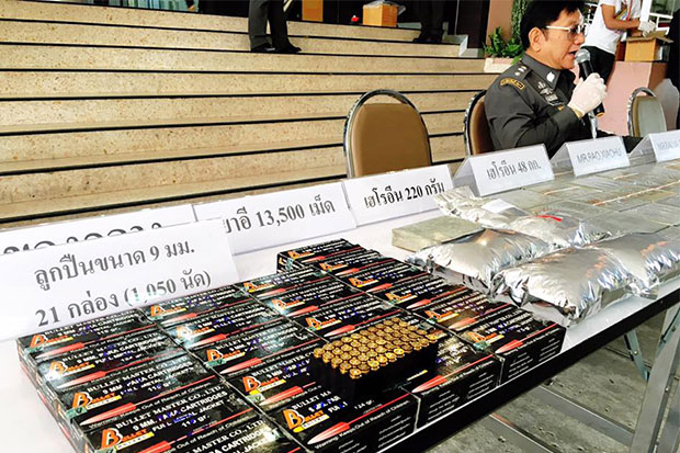 A total of 48 kilogrammes of compressed heroin, 13,500 ecstasy pills and 1,050 rounds of 9mm ammunition seized from four accused drug traffickers are displayed during a media briefing at the Narcotics Suppression Bureau on Saturday. (Photo taken from the NSB Facebook page)