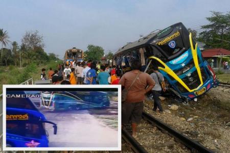 Train hits bus at railway crossing, killing 3, injuring 30