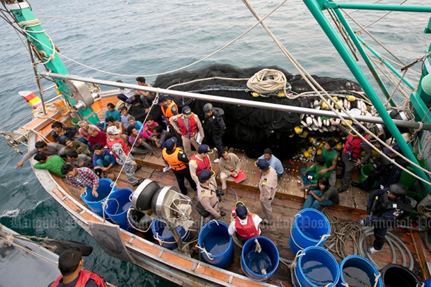 Crew members of a fishing boat gather on deck as authorities inspect their vessel in Chon Buri’s Sattahip district in Febuary 2016. The inspection is part of a field training programme by the Command Centre to Combat Illegal Fishing to fight human trafficking and forced labour. (Bangkok Post file photo)