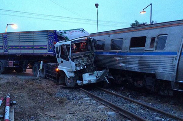 Truck hits train on crossing, injuring 3