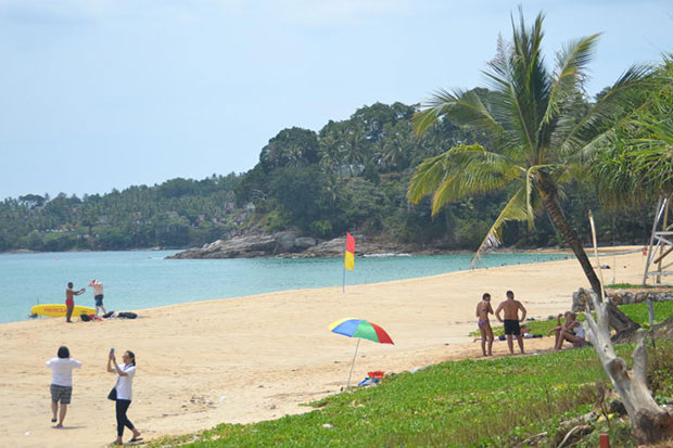 Tourists enjoy the scenic views at Surin beach in Phuket on Friday. The resort island is popular with Russian travellers. (Photo by Achadtaya Chuenniran)