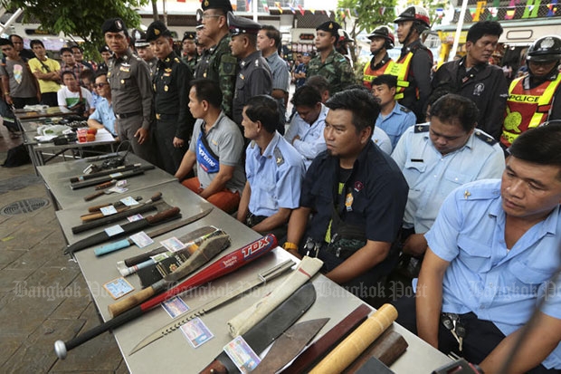 Passenger van drivers appear at a media briefing with various weapons found inside their vehicles following a search around Victory Monument in Bangkok on Friday. (Photo by Patipat Janthong)