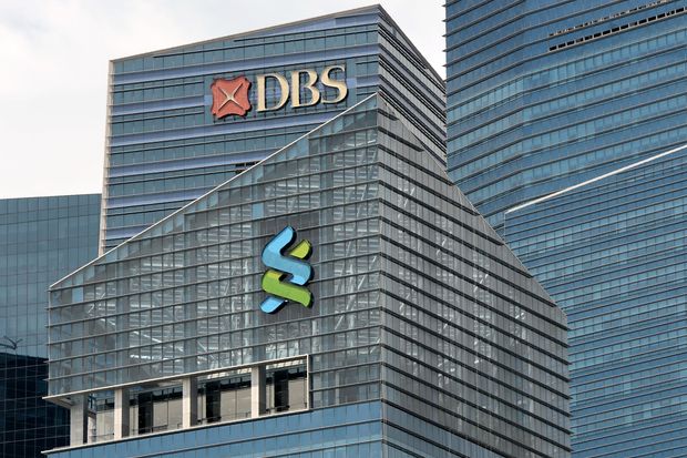 A DBS (top) and Standard Chartered bank logo (centre) are seen on the building at Marina Bay financial district in Singapore on July 21, 2016. (AFP photo) A DBS (top) and Standard Chartered bank logo (centre) are seen on the building at Marina Bay financial district in Singapore on July 21, 2016. (AFP photo)