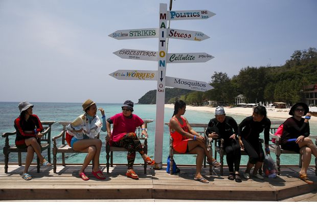 Tourists sit as they wait for their boat at Maiton Island in Phuket on March 18, 2016. (Reuters photo)