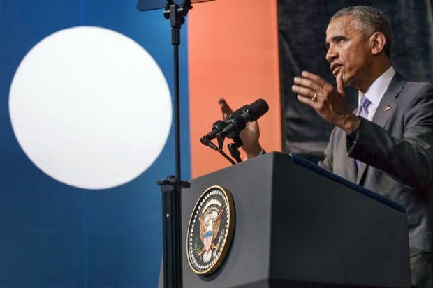 President Obama, with a huge Lao flag in the background,said it was time to 'acknowledge the suffering and sacrifices' from America's secret war in Laos, and pledged increased aid to find and dismantle unexploded bombs. (The New York Times)