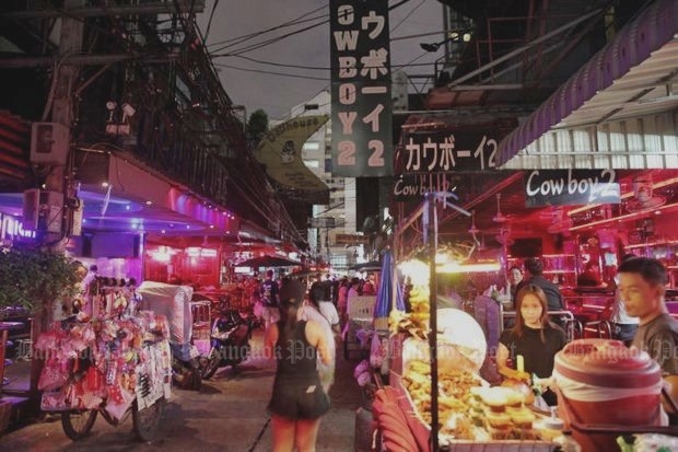 Soi Cowboy, an entertainment area off Sukhumvit Soi 23, has turned off the neon and turned down the beat, while the street's girls are still in risque outfits, only all-black. (Photo by Wichan Charoenkiatpakul)