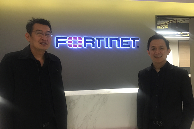 Peerapong Jongvibool, right, vice-president of Fortinet Inc and Wittaya Janmayka, the company's network security architect join a press conference discussing cybersecurity.