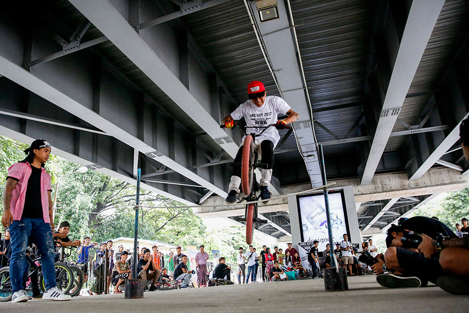 A cyclist displays his skills on a BMX bike during second Myanmar's BMX