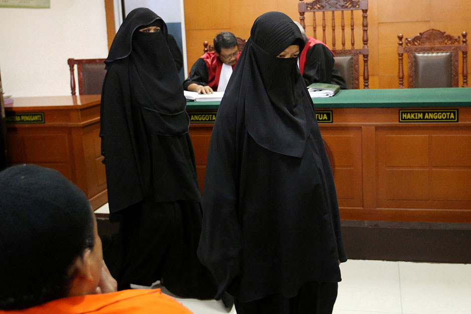Indonesian militant Dian Yulia Novi (right) walks with her recruiter Tutin, as they attend their trial hearing at East Jakarta District Court in Jakarta. Novi, an alleged would-be suicide bomber, was arrested before the planned bombing of a popular family attraction in the Indonesian capital. — AP