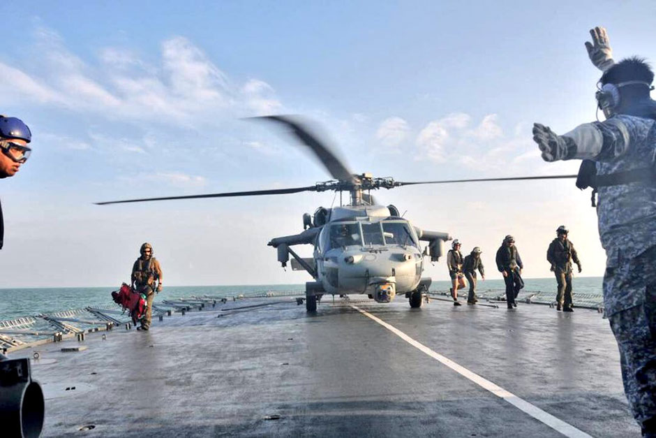 A US Navy helicopter from USS America lands on Royal Malaysia Navy's KD Lekiu Frigate 30 during a search and rescue operation for survivors of the USS John S. McCain ship collision in Malaysian waters. — Royal Malaysian Navy/Reuters