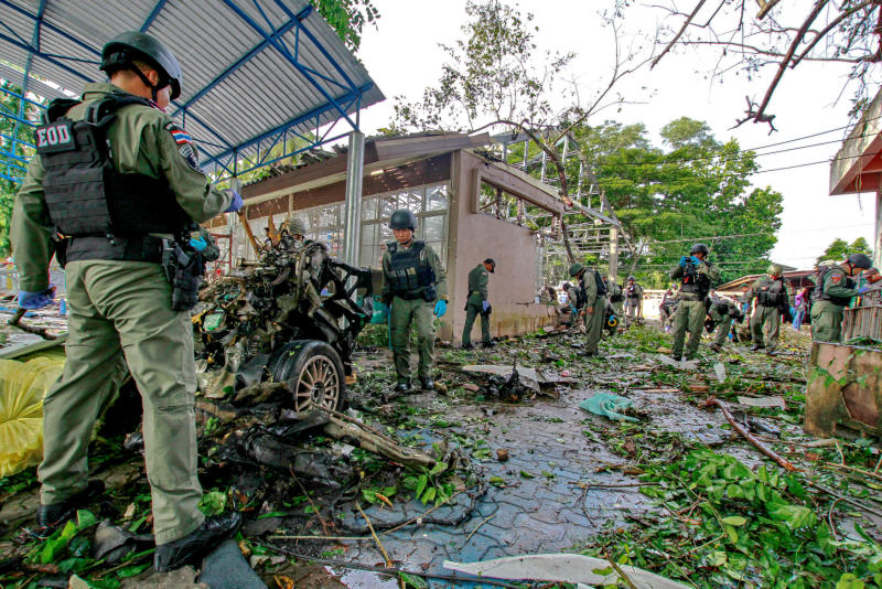 Military personnel inspect the site of a bomb attack in Yaring district, Pattani, on Nov 18, 2016. Army chief Gen Chalermchai Sittisat says he is confident violent unrest in the far South will be ease in the near future. — Reuters