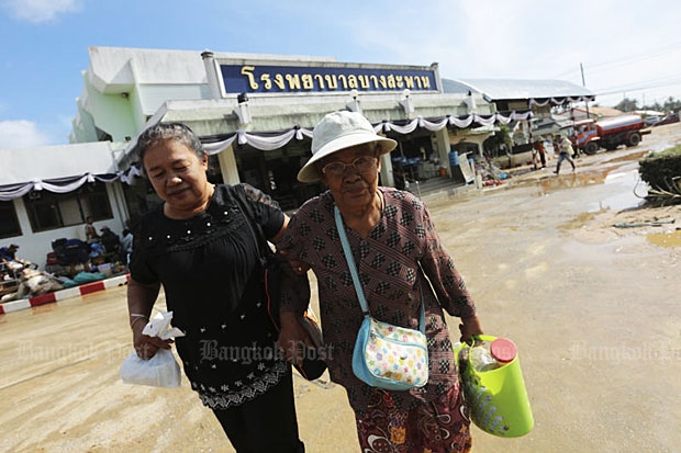 Two women leave Bang Saphan Hospital in Bang Saphan district of Prachuap Khiri Khan after a hospital visit on Thursday. (Photo by Patipat Janthong)