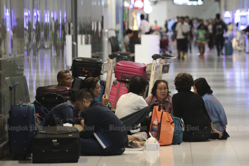 Passengers were stranded at Suvarnabhumi airport on Tuesday night after discovering there was no trip to Japan after all. (Photo by Patipat Janthong)