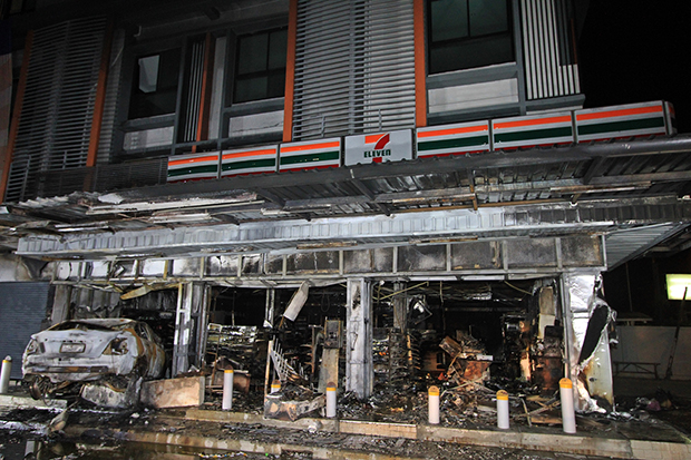 The fire gutted 7-Eleven after a car crashed into it in Pathum Thani overnight.   (Photo by Pongpat Wongyala)