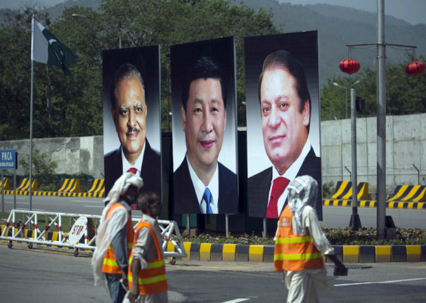 A billboard showing pictures of Chinese President Xi Jinping, centre, with Pakistan's President Mamnoon Hussain, left, and Prime Minister Nawaz Sharif on display during a visit by the Chinese president to launch an ambitious $45 billion economic corridor linking Pakistan's port city of Gwadar with western China, in Islamabad, Pakistan. (AP Photo/B.K. Bangash, File)