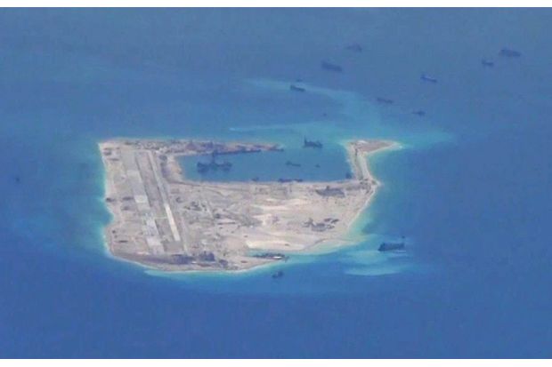 Chinese dredging vessels are purportedly seen in the waters around Fiery Cross Reef in the disputed Spratly Islands in the South China Sea in this still image from video taken by a P-8A Poseidon surveillance aircraft provided by the US Navy on May 21, 2015. (Reuters photo)